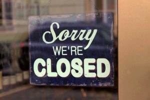 Sign on window saying 'we're closed'